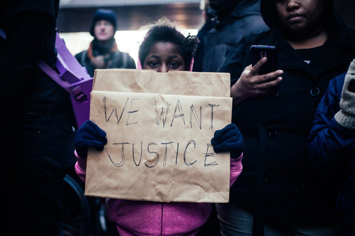 A young girl marches with protesters in downtown Minneapolis on Nov. 24
